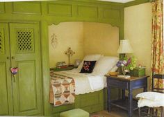 a bedroom with green painted walls and furniture