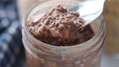 a spoon in a jar filled with chocolate pudding