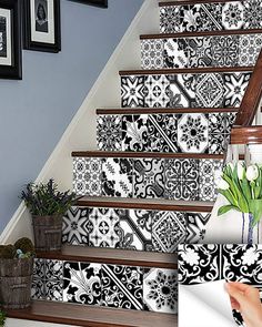 the stairs are decorated with black and white wallpaper as well as tulips