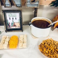 a table topped with lots of food next to a sign