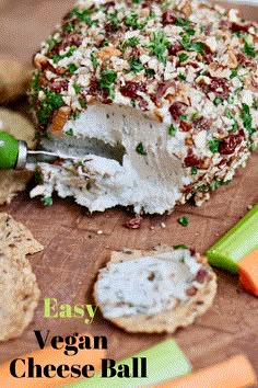 an easy vegan cheese ball on a cutting board with crackers