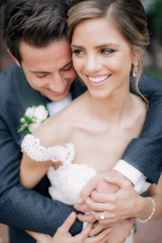 a bride and groom embracing each other