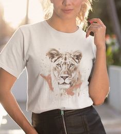 Introducing our fierce and captivating Lioness Grunge T-Shirt, designed to showcase the untamed spirit and raw power of the queen of the jungle. This unique and edgy t-shirt combines the majestic beauty of a lioness with the gritty aesthetic of grunge fashion, creating a truly striking and captivating design. The front of the t-shirt features a bold, high-resolution graphic depicting a lioness in all her glory. Her piercing gaze and strong, regal stance exude confidence and dominance. The details of her expressive eyes, sharp fangs, and flowing mane are intricately rendered, capturing the essence of her majestic presence. The grunge-inspired styling adds an element of urban attitude and rebelliousness to the design, giving it a distinct and contemporary appeal. .: 100% Airlume combed and r Lioness Design, Lioness Kenny Jacket, Lioness Clothing, Gritty Aesthetic, Lioness Rendezvous Dress, The Lioness Book, Grunge Tshirt, Queen Of The Jungle, Female Lion