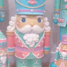 a nutcracker with a blue crown on it's head and two other toy figures