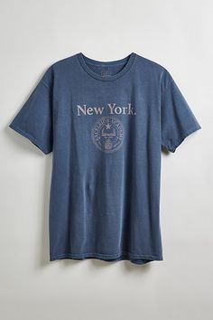 New York Crest graphic tee. Academia-inspired tee features a distressed-finish graphic at the front of the cotton jersey design. In a standard fit with a ribbed crew neck and short sleeves. Features New York crest graphic tee Regular fit Ribbed crew neck Short sleeves Content + Care 100% Cotton Machine wash Imported Size + Fit Model in Navy is 6’2" and wearing size Large Measurements taken from size Large Chest: 46" Length: 30" | New York Crest Tee in Navy, Men's at Urban Outfitters Mens Home, Jersey Design, Urban Outfitters, Fitness Models, Sign Up, Graphic Tees, Shop Now, Short Sleeves, Crew Neck