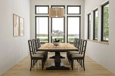 a dining room table with six chairs and a potted plant in the center is surrounded by windows