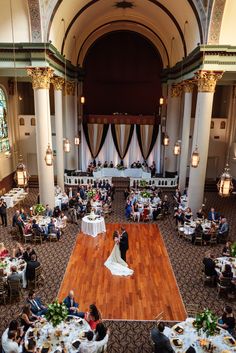 an overhead view of a wedding reception in the grand hall with people sitting at tables