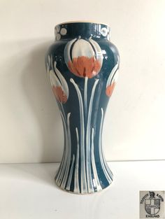 a blue and white vase sitting on top of a table