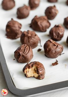 chocolate bites on a baking sheet with the bite taken out