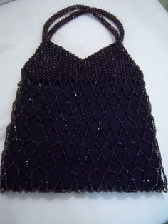 "Black diamond pattern beaded purse was made in Barcelona, Spain and measures 15\" tall including handles x 10\" wide x 1\" deep lying flat. This purse is lined in black silk and is in excellent condition. Secure clasp. Perfect as an accessory for any formal or special occasion." Elegant Evening Bag With Black Beads For Party, Elegant Evening Bags With Black Beads, Elegant Black Beaded Rectangular Evening Bag, Elegant Rectangular Black Beaded Evening Bag, Elegant Black Beaded Evening Bag For Party, Elegant Black Beaded Evening Bag For Formal Occasions, Formal Rectangular Bag With Black Beads, Black Beaded Formal Evening Bag, Black Beaded Evening Bag