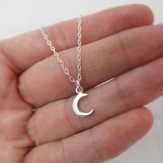 ALL STERLING SILVER - A GREAT KEEPSAKEThis celestial necklace is lovingly hand-made with all solid sterling silver parts, making it a thoughtful gift (even for yourself!). A tiny moon dangles elegantly from the sparkly chain. Closes with an easy-to-use spring clasp. Moon charm measures approximately 3/8 inch tall. Comes in a gift box, perfect for gift-giving. **SIZING - PLEASE READ:Select your necklace size at checkout. Note that necklaces will fit differently depending on a person's size. Pleas Sterling Silver Moon Charm Jewelry Gift For Her, Silver Celestial Charm Necklaces For Everyday, Silver Celestial Charm Necklace For Everyday, Everyday Celestial Sterling Silver Charm Necklaces, Adjustable Sterling Silver Charm Necklace With Moon Charm, Sterling Silver Moon Charm Necklace For Everyday, Sterling Silver Moon Charm Necklace For Gift, Handmade Celestial Sterling Silver Charm Necklace, Silver Crescent Sterling Silver Charm Necklace