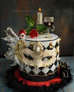 a cake decorated with black, white and red decorations