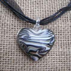 Handmade Murano Glass Heart Necklace. 3d Style. Clear Glass On Outside. White, Black, And Metallic Gold Stripes And Swirls Inside. Heart Is 1 3/4 Inches High, 1 1/2 Inches Wide. On A Black 18 Inch Cord And Ribbon Necklace That Closes With A Lobster Clasp And Has An Adjustable Chain Tail. Necklace Is Made Up Of 4 Cords And 1 Sheer Ribbon. New Item From My Local Shop. Great For Anyone Who Likes Hearts Or Art Glass. Tags: Glass, Love, Casual, Everyday, Dressy, Art Glass, Hearts, Stripes, Swirls, Ri Glass Heart Necklace, Glass Hearts, Local Shop, Ribbon Necklace, Gold Stripes, Glass Heart, Casual Everyday, Heart Pendant Necklace, Murano Glass