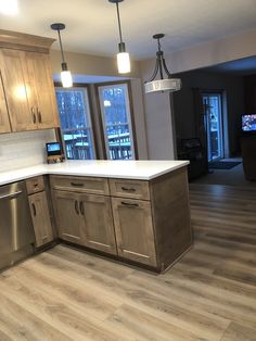 an empty kitchen with wooden cabinets and stainless steel appliances