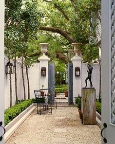 an outdoor patio with tables and chairs under trees