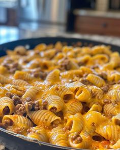 a casserole dish with meat and cheese in it sitting on a counter top