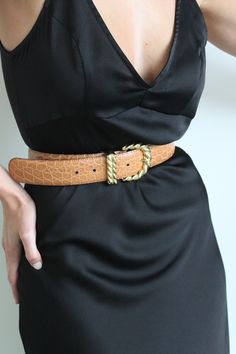 Beautiful leather belt with an embossed leather body, gold toned buckle, prong and loop. Belt buckle features a twisted appearance. Perfect styled here with our Townes Trousers, Na Nin swim as a bodysuit, & favorite vintage blazer. Holes can be added to belt as desired to fit smaller waist sizes. Made in Italy Light scratching at the belt buckle and loops, very minimal and does not affect look or wear. Gold Leather Belt For Fall, Trendy Gold Belt For Fall, Trendy Gold Belts For Fall, Gold Belt Buckles For Work, Chic Brown Belt Buckles For Formal Occasions, Chic Formal Belts For Fall, Chic Leather Belt Buckles With Antique Buckle, Chic Leather Belt Buckle With Antique Detail, Chic Leather Belt Buckle With Antique Design