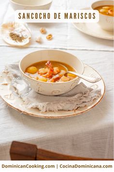 a white bowl filled with soup sitting on top of a table