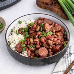 a bowl filled with beans and rice on top of a table