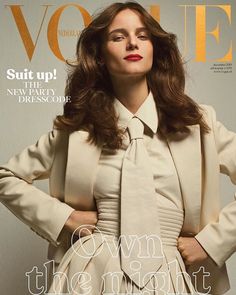 a woman wearing a white suit and tie on the cover of a magazine with her hands on her hips