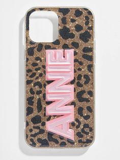 an animal print phone case with the word annie in pink and gold glitter on it