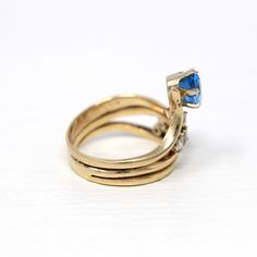 Stunning & unique vintage 14k yellow gold ring featuring a genuine swiss blue topaz gem. The asymmetrical ring contains 6 sparkling diamond accents, with an oval cut blue topaz weighing approximately 1.47 carats. A truly rare & one of a kind gemstone ring! ERA - Circa 1980s METAL / MATERIAL - 14k yellow gold, 1 genuine blue topaz gemstone (estimated 1.47 carats), 6 genuine diamonds (approx. .30 ctw, SI clarity range, near colorless) MARKINGS / HISTORY - Inside of band is stamped 14k COND Yellow Gold Blue Topaz Birthstone Ring For Anniversary, Heirloom Topaz Ring In 14k Gold For Anniversary, Heirloom 14k Gold Topaz Ring For Anniversary, Heirloom Style 14k Gold Topaz Ring For Anniversary, Blue Topaz Yellow Gold Birthstone Ring For Anniversary, Blue Topaz Ring Stamped 14k Gold, Vintage 14k Gold Rings With Accent Stones, Vintage Blue Topaz Ring For Anniversary, Vintage Topaz Ring In Sapphire Color