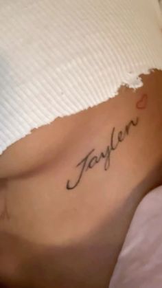 a woman's stomach with the word taylor written in cursive writing on it