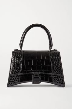 Balenciaga's 'Hourglass' bags are inspired by the label's sculptural blazers. This small tote has been crafted in Italy from croc-effect leather and detailed with a brushed silver 'B' at the front flap. Store your wallet, phone and a paperback inside, removing the adjustable shoulder strap to carry it by the top handle. Balenciaga Hourgkass Bag, Balenciaga Hourglass Purse, Balenciaga Hourglass Wallet, Balenciaga Mini Bag, Balenciaga Tote, Black Balenciaga, Balenciaga Women, Balenciaga Black, Cheap Bags