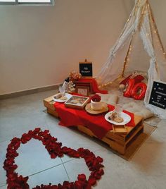 a table set up with food and decorations in the shape of a heart