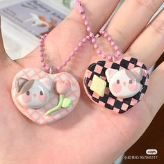 there are two small animals on the palm of someone's hand, one is wearing a necklace