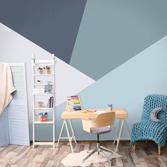 a room with a chair, desk and bookshelf on the wall painted in shades of blue and grey