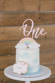 there is a cake on the table and one has a rainbow