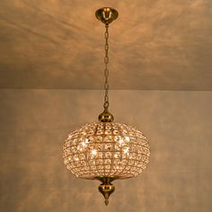 a chandelier hanging from the ceiling in a room with no one around it