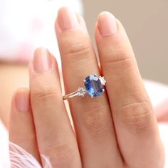 With a brilliant cut like that, this ring is nothing but pure brilliance in itself. With a lovely Kyanite, the Khloe ring with two side moissanite sparkles like there is no tomorrow. Celebrate your milestones or special occasions with this ring as the perfect gift for sisters as a best friend's gift, or just as an everyday celebration of life in general. Details: Center stone Gemstone: Kyanite Stone Shape: Oval Measurements: approx. 9x7mm Side stones Gemstone: Moissanite Shape: Round Measurement Oval Sapphire Diamond Ring With Brilliant Cut, Dazzling Oval Sapphire Ring With Brilliant Cut, Dazzling Oval Sapphire Diamond Ring, Proposal Sapphire Ring With Cubic Zirconia Accent Stones, Dazzling Oval Sapphire Gemstone Ring, Oval Sapphire Ring With Diamond Center Stone, Oval Sapphire Diamond Ring With Prong Setting, Dazzling Sapphire Diamond Ring, Oval Shape, Sapphire Diamond Ring With Prong Setting In Oval Shape