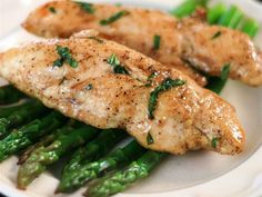 chicken and asparagus on a white plate with the words lucky's quickie chicken