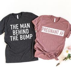 two t - shirts that say the man behind the bump are next to each other