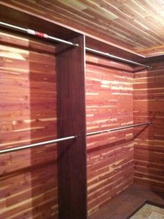 an empty walk in closet with wooden walls