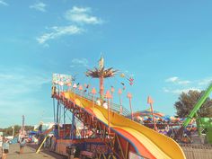 a carnival ride with people walking around it