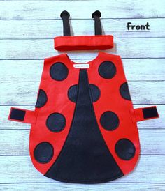 Loving my little ladybird costume!! Perfect outfit to wear to any mini beast or bug party! Handmade from quality felts with adjustable non-scratch velcro fastenings. Sturdy tabard with shoulder and side tab adjustable velcro fastenings...pop over a top and match with leggings or tights. Cute antenna crown band with easy adjustable velcro fastening. 100% Acrylic Sponge clean only Sizes available are : Size                        Tabard                            Measurement 3 - 4 years -      33cm w x 47cm shoulder to hemline 5 - 6 years -      35cm w x 57cm shoulder to hemline 7 - 8 years -       37cm w x 65cm shoulder to hemline PLEASE NOTE Colours / placements may differ slightly to the screen photo's. Non-scratch velcro is used on all openings with a quick release. Processing & shipping Ladybird Costume, School Props, Flower Costume Kids, Ladybug Headband, Ladybug Outfits, Goose Clothes, Ladybug Costume, World Book Day Costumes, Baby Ladybug