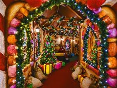 an archway decorated with christmas lights and presents