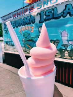 a pink ice cream sundae with a straw sticking out of it's top