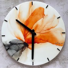 a clock with an orange flower painted on it