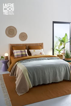 a bedroom with a large bed and two planters on the side of the wall