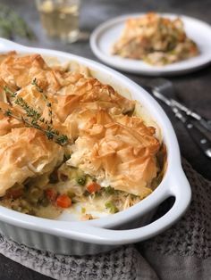 a casserole dish with meat and vegetables in it on top of a table