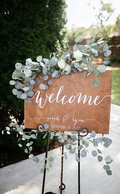 a welcome sign with flowers on it