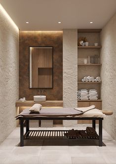 a bathroom with stone walls and shelves filled with towels