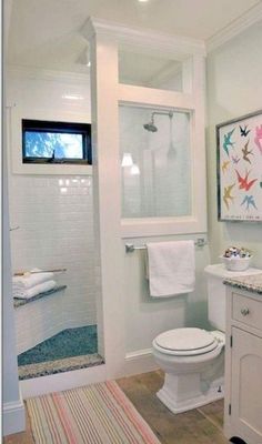 a bathroom with a toilet, sink and shower