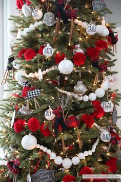 a christmas tree decorated with red, white and black ornaments