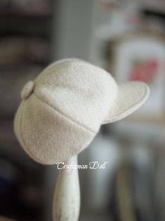 a white hat on top of a wooden stick