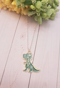 This cool dinosaur Charm Necklace is the perfect gift for someone special!  The charm is made of high-quality gold. This makes an excellent gift for yourself or your friends and family members who loves to collect Dinosaur jewelry. Product Details: Material: Sterling silver plated necklace Chain Length: 18 Inches (Can be made in different lengths) Charms: Dinosaur Charm. Please reach out to me  You can get these personalized necklaces in any length, so please contact me via Etsy Conversations if you need any size. This minimalist and dainty necklace is made with a high-quality material that is eco-friendly, durable, and anti-inflammatory. It won't leave your skin green due to marks. Moreover, the weight of the necklace is quite appropriate, and they come with a Lobster Clasp to provide you Novelty Charm Necklaces For Gifts, Nickel-free Novelty Charm Necklace For Gift, Novelty Necklace With Lobster Clasp For Gift, Novelty Pendant Charm Necklace As Gift, Novelty Pendant Charm Necklace Gift, Novelty Pendant Charm Necklace For Gift, Themed Pendant Necklaces As A Gift, Themed Pendant Necklace For Gifts, Novelty Green Necklace For Gifts